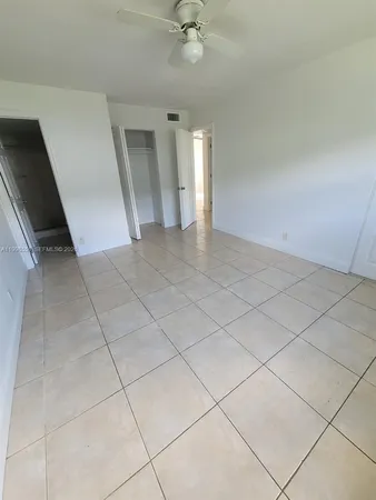 a view of an empty room and a window