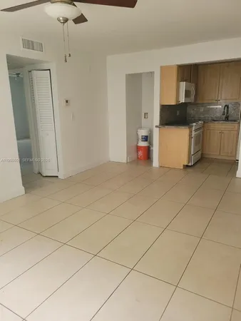 a kitchen with granite countertop cabinets and white appliances