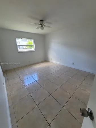 a view of an empty room and a window