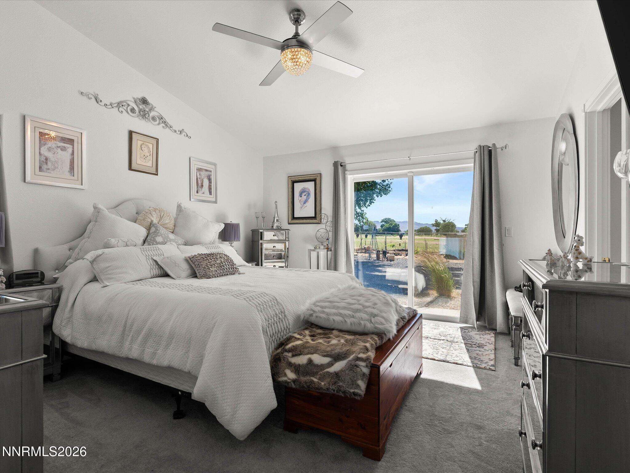 1080 Red Rock Road Fernley, NV 89408 - Photo 20 of 45 a spacious bedroom with a bed a couch and a chandelier
