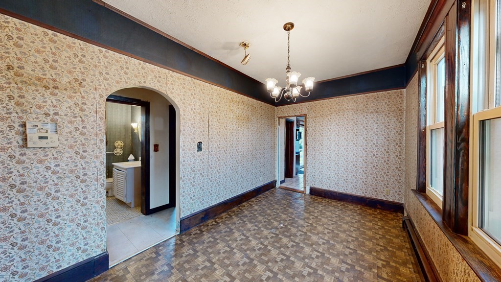 41 Echo Avenue Beverly, MA 01915 - Photo 12 of 24 a view of a hallway with wooden floor and chandelier