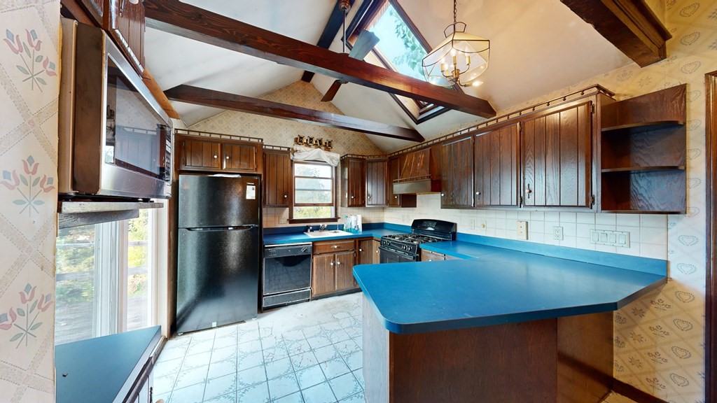 41 Echo Avenue Beverly, MA 01915 - Photo 13 of 24 a kitchen with stainless steel appliances granite countertop a sink refrigerator and cabinets