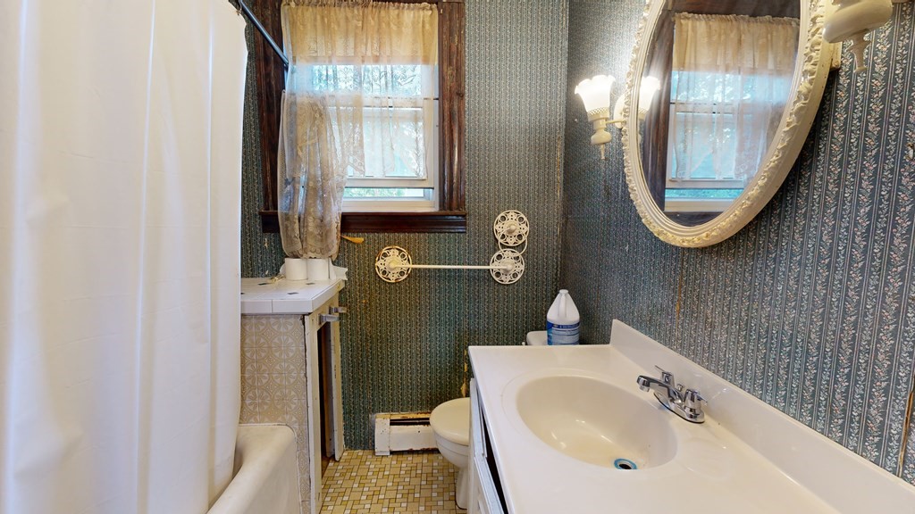 41 Echo Avenue Beverly, MA 01915 - Photo 16 of 24 a bathroom with a sink a toilet and a mirror