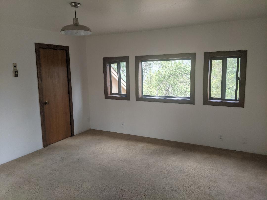 12877 Bobs Mountain Road Redding, CA 96003 - Photo 14 of 51 an empty room with windows