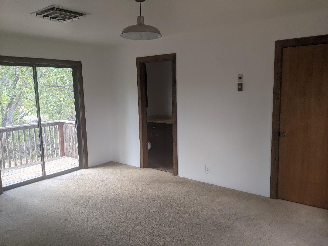 12877 Bobs Mountain Road Redding, CA 96003 - Photo 16 of 51 a view of empty room with wooden floor