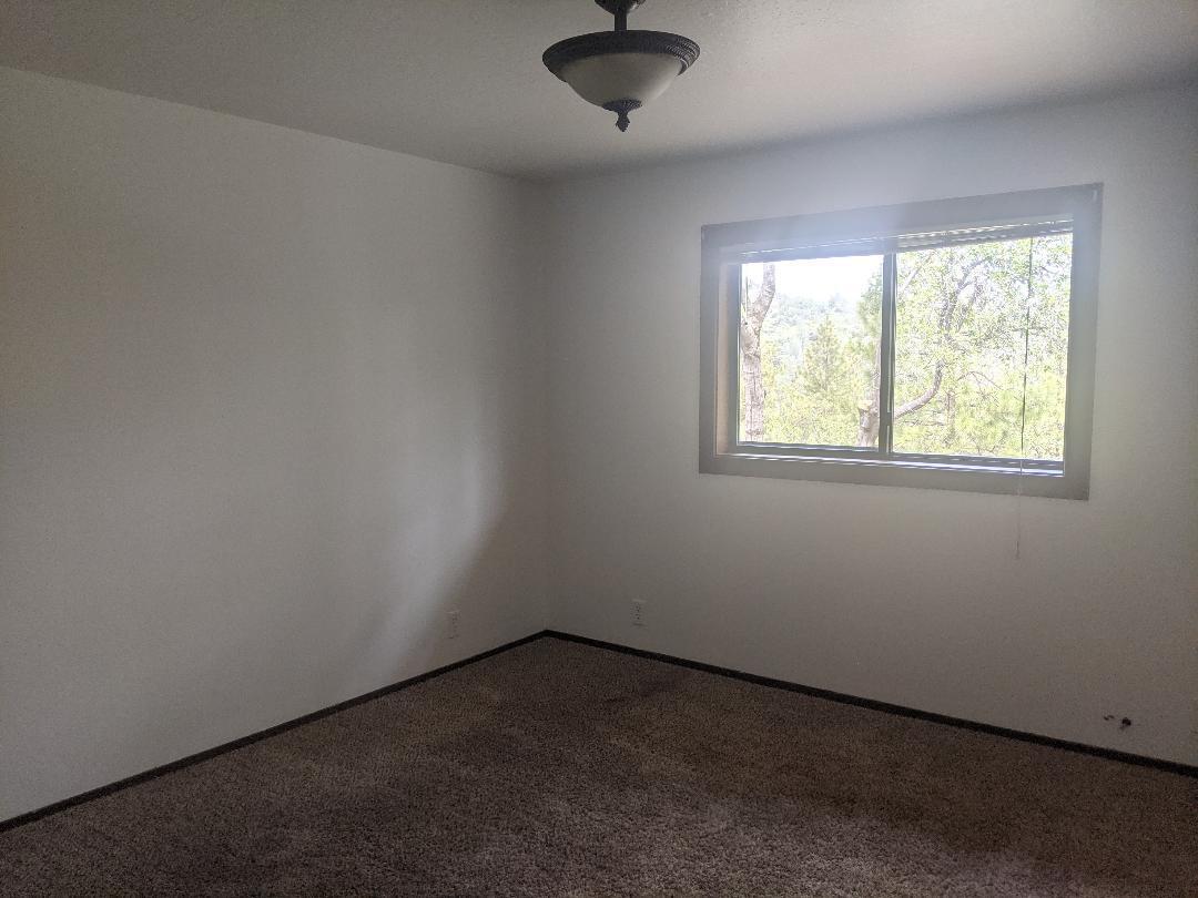 12877 Bobs Mountain Road Redding, CA 96003 - Photo 21 of 51 an empty room with a window