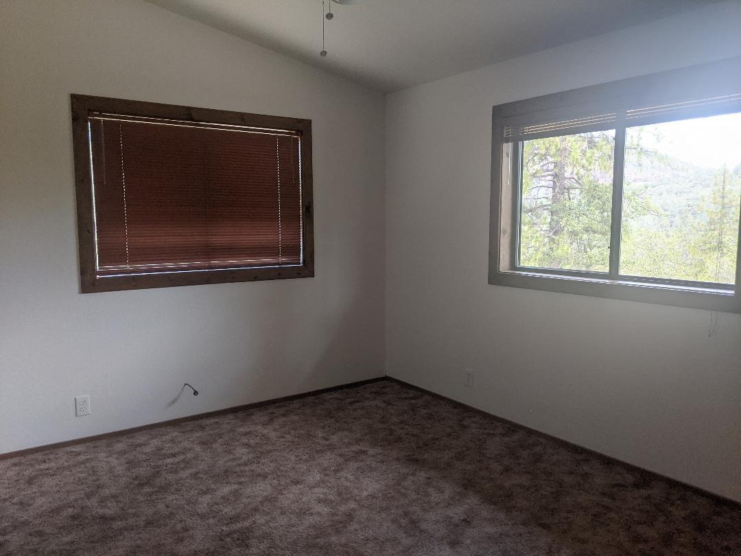 12877 Bobs Mountain Road Redding, CA 96003 - Photo 22 of 51 an empty room with a window