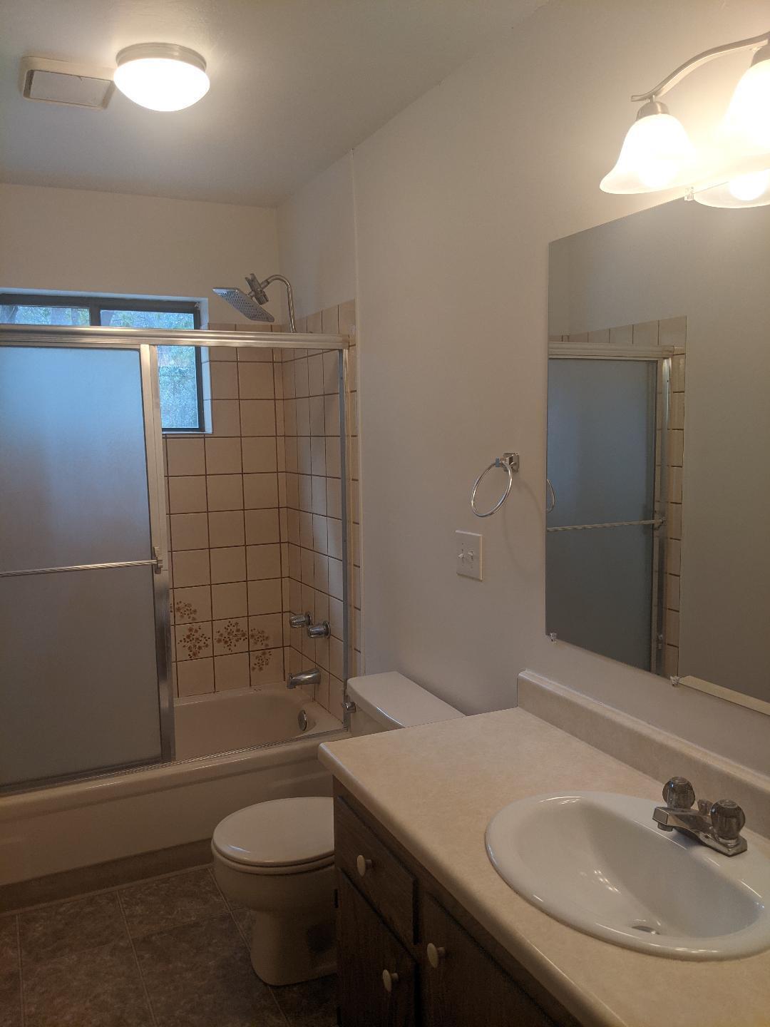 12877 Bobs Mountain Road Redding, CA 96003 - Photo 23 of 51 a bathroom with a sink a toilet and shower