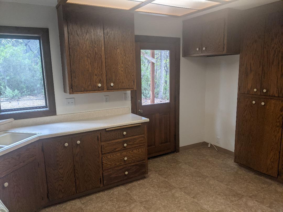 12877 Bobs Mountain Road Redding, CA 96003 - Photo 8 of 51 an empty room with window and cabinet