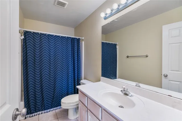 a view of workspace with lounge chair and windows