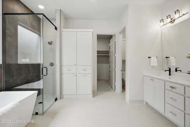 a bathroom with a tub a sink and mirrors