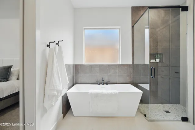 a bathroom with a bathtub and a shower