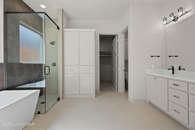 a bathroom with a tub sink and mirror