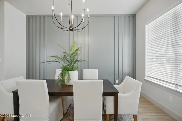 a view of a dining room with furniture and a potted plant