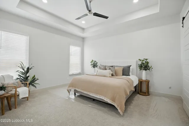 a bedroom with a bed and a potted plant