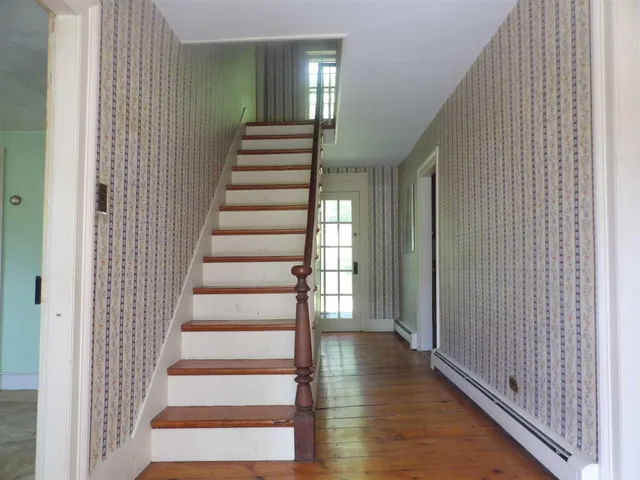 a view of entryway with wooden floor