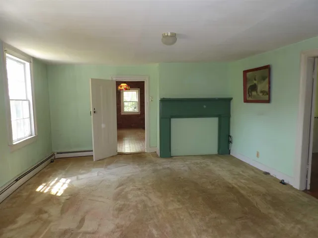 an empty room with windows and closet