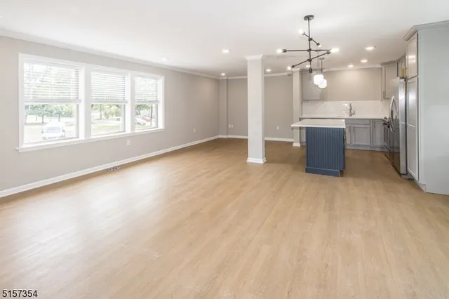 a large kitchen with stainless steel appliances granite countertop a stove a sink and a refrigerator