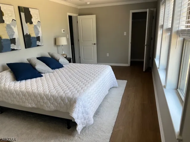 a bedroom with a bed and a night stand