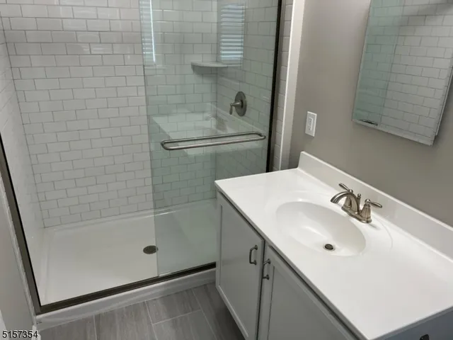 a bedroom with a bed and painting on the wall