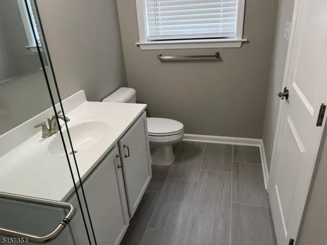 a white toilet sitting next to a bathroom sink