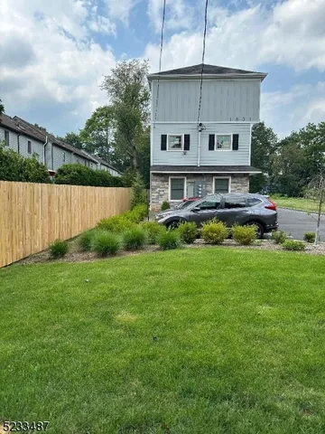 a view of a chair and table in backyard of the house