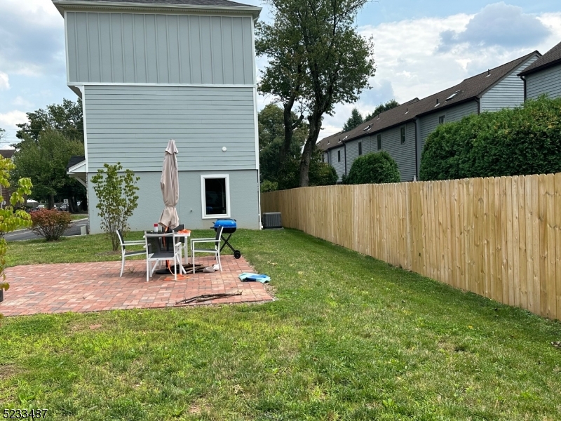 1801 Front Street, Unit A Scotch Plains, NJ 07076 - Photo 29 of 31 a view of a chair and table in backyard of the house