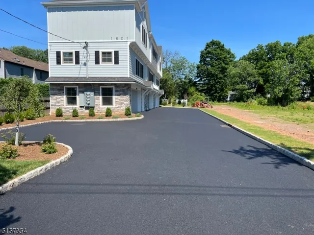 a front view of a house with yard and green space