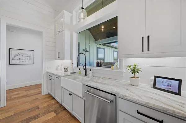 a spacious en suite bathroom with a granite countertop sink and mirror