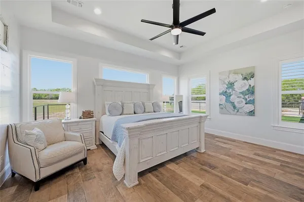 a bedroom with a large bed couch and a window