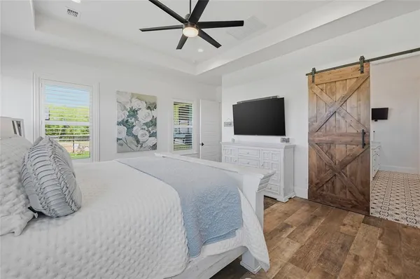 a bedroom with a bed and a flat screen tv