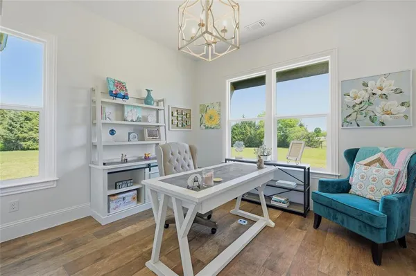 a view of a dining room with furniture window and wooden floor