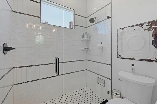 a bathroom with a shower and toilet