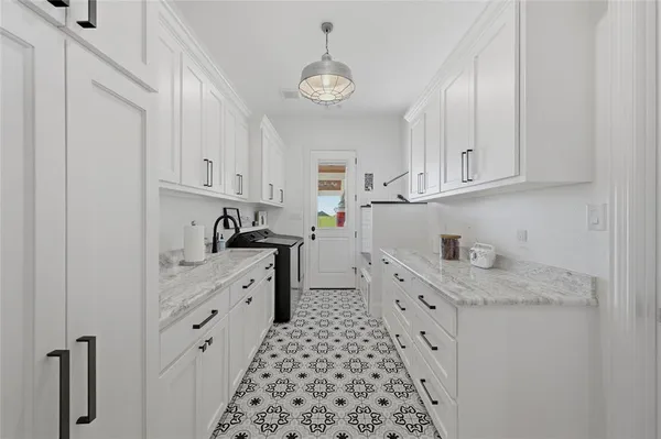 a kitchen with granite countertop a sink and cabinets