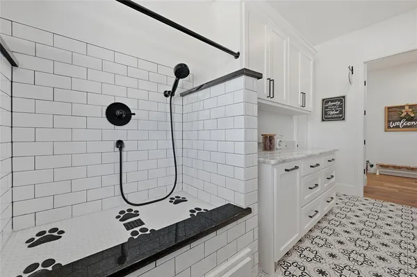 a bathroom with a sink mirror and shower