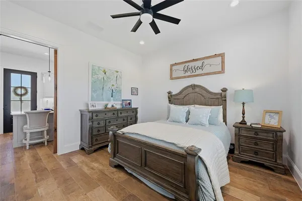 a bedroom with a bed and a chandelier