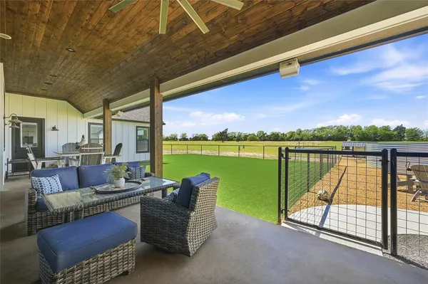 a building outdoor space with seating area and lake view