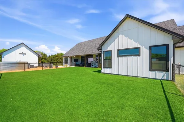 a view of house with backyard and entertaining space