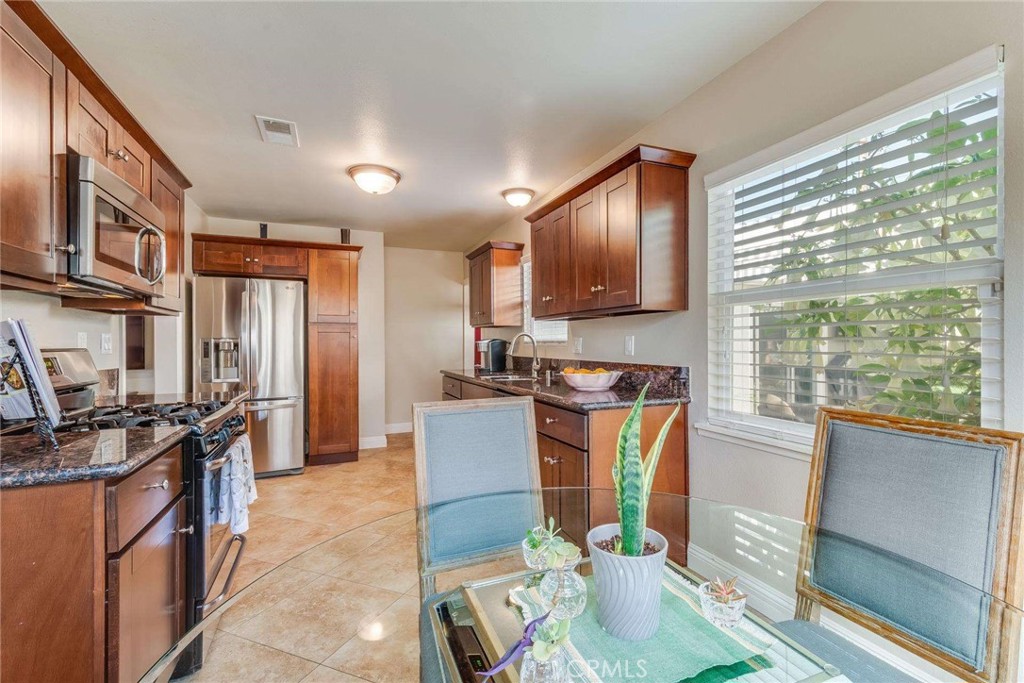 749 East Baseline Road San Dimas, CA 91773 - Photo 26 of 35 a kitchen with stainless steel appliances granite countertop sink stove top oven and cabinets
