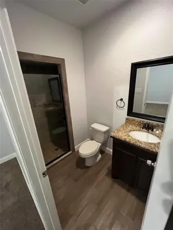 a bathroom with a granite countertop sink and mirror