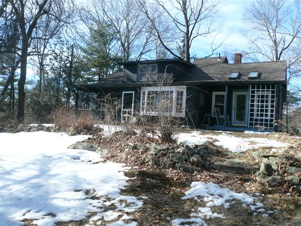 563 Montague Road Amherst, MA 01002 - Photo 1 of 15 a front view of a house with a yard covered in snow
