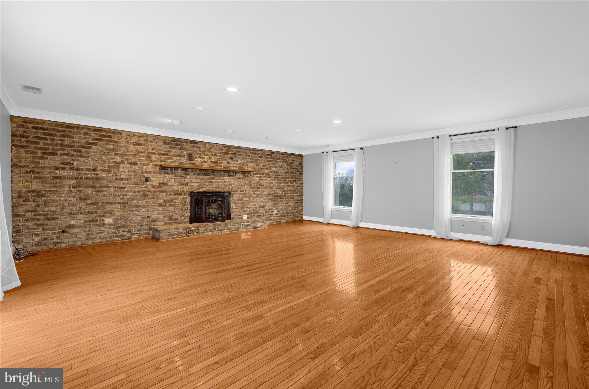 3300 Paper Mill Road Phoenix, MD 21131 - Photo 12 of 91 a view of empty room with wooden floor and fireplace