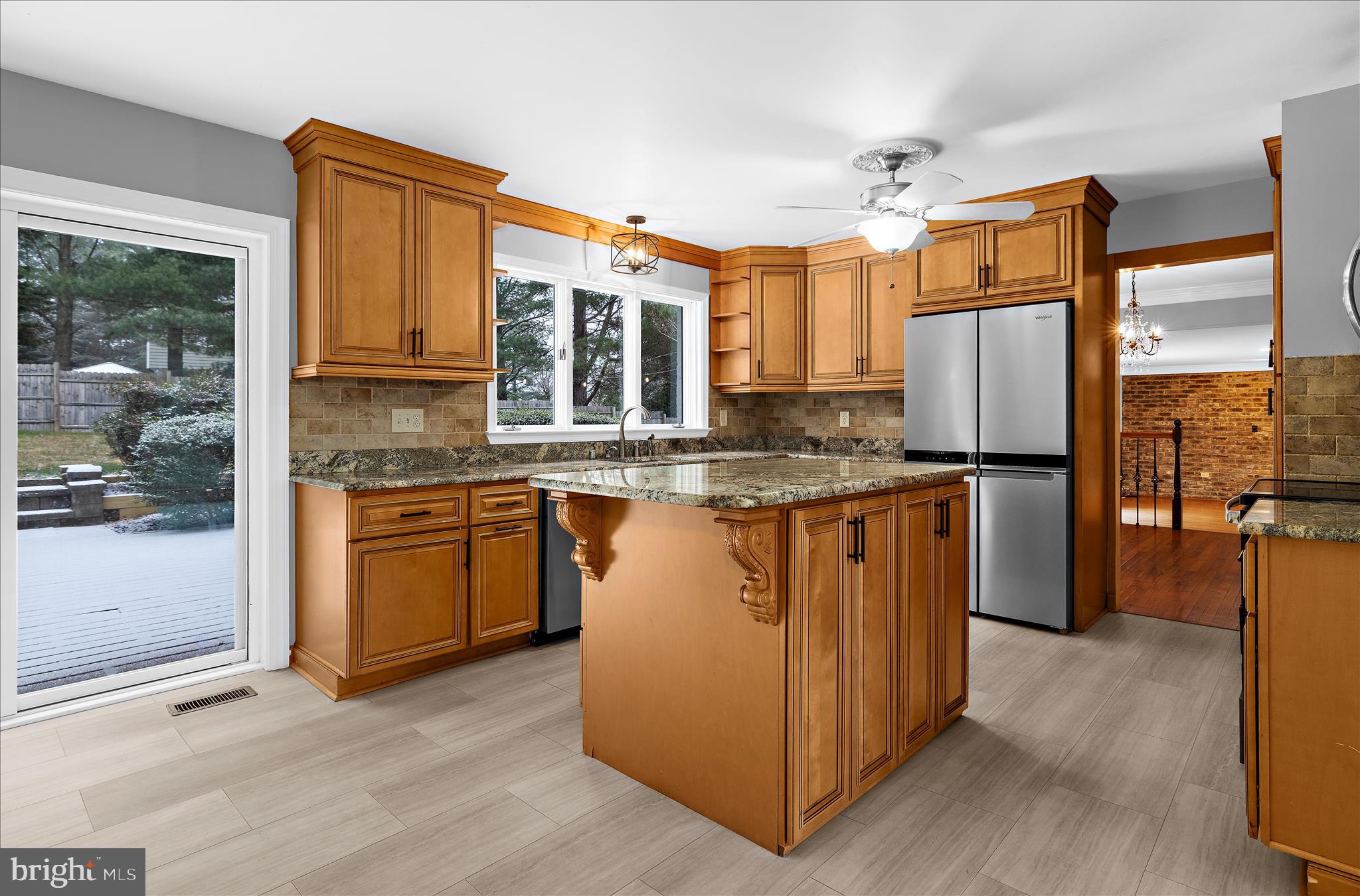 3300 Paper Mill Road Phoenix, MD 21131 - Photo 22 of 91 a kitchen with stainless steel appliances granite countertop a refrigerator a sink dishwasher a stove and a dining table with wooden floor