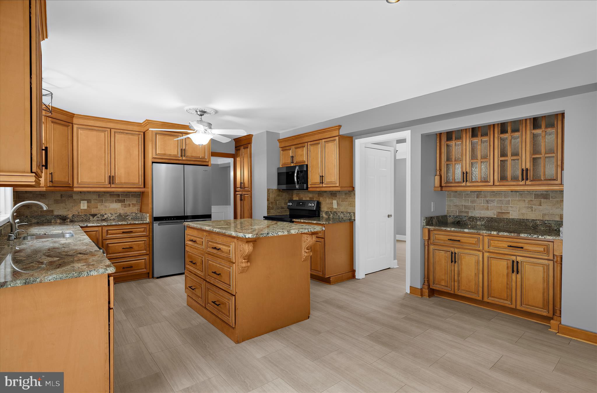 3300 Paper Mill Road Phoenix, MD 21131 - Photo 24 of 91 a kitchen with stainless steel appliances granite countertop a stove top oven a refrigerator a sink and dishwasher wooden cabinets with wooden floor