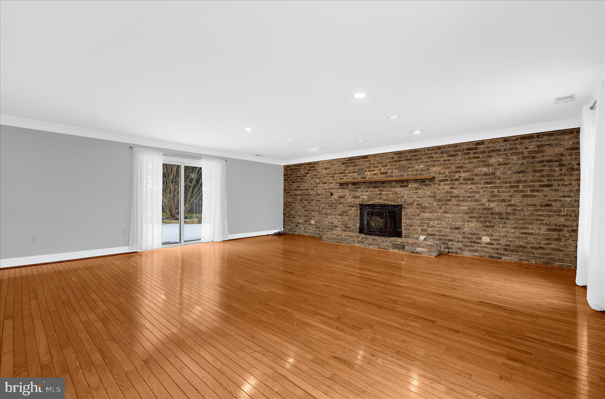 3300 Paper Mill Road Phoenix, MD 21131 - Photo 8 of 91 a view of empty room with wooden floor and fireplace