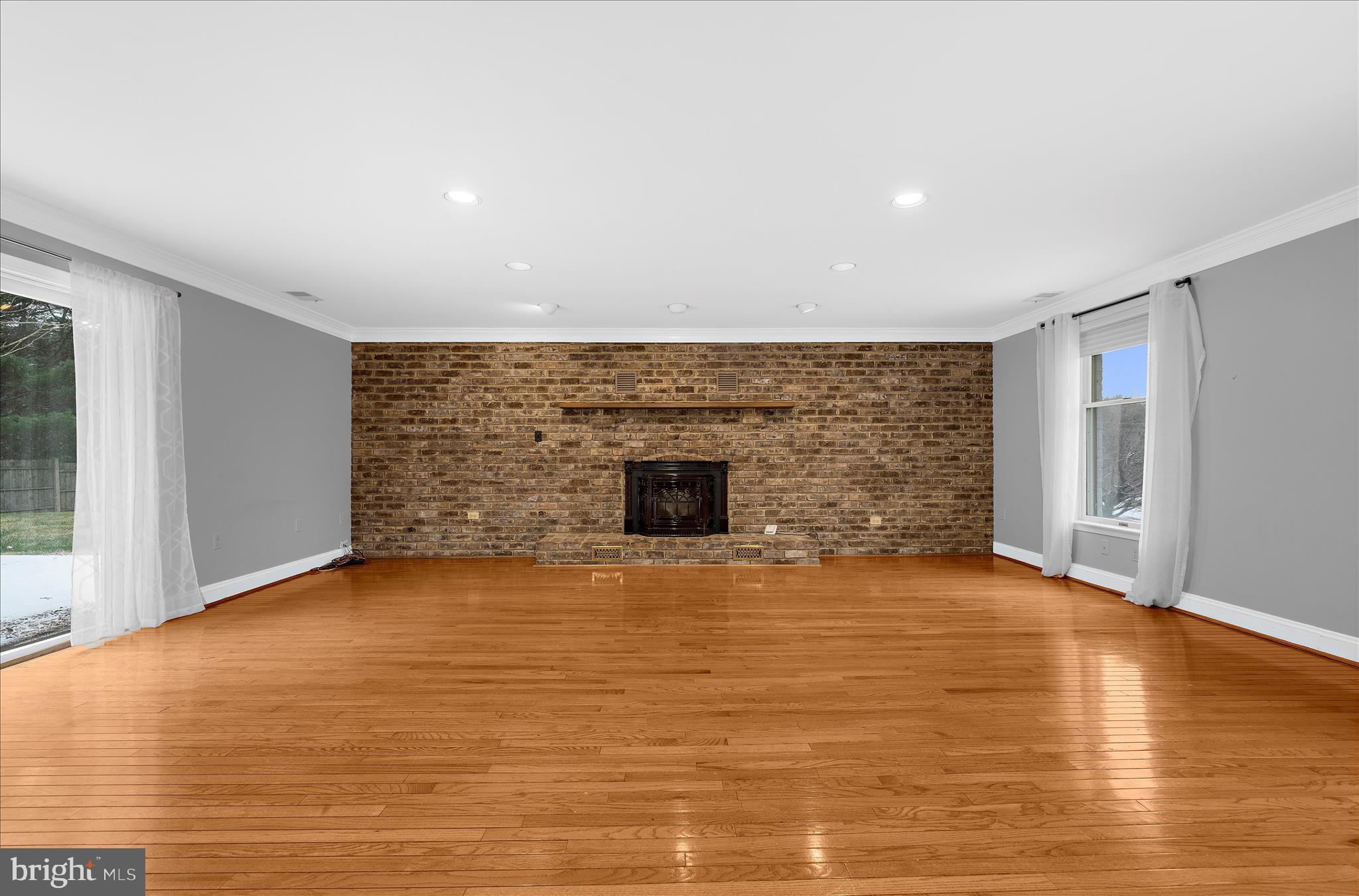 3300 Paper Mill Road Phoenix, MD 21131 - Photo 9 of 91 a view of an empty room with wooden floor and a fireplace