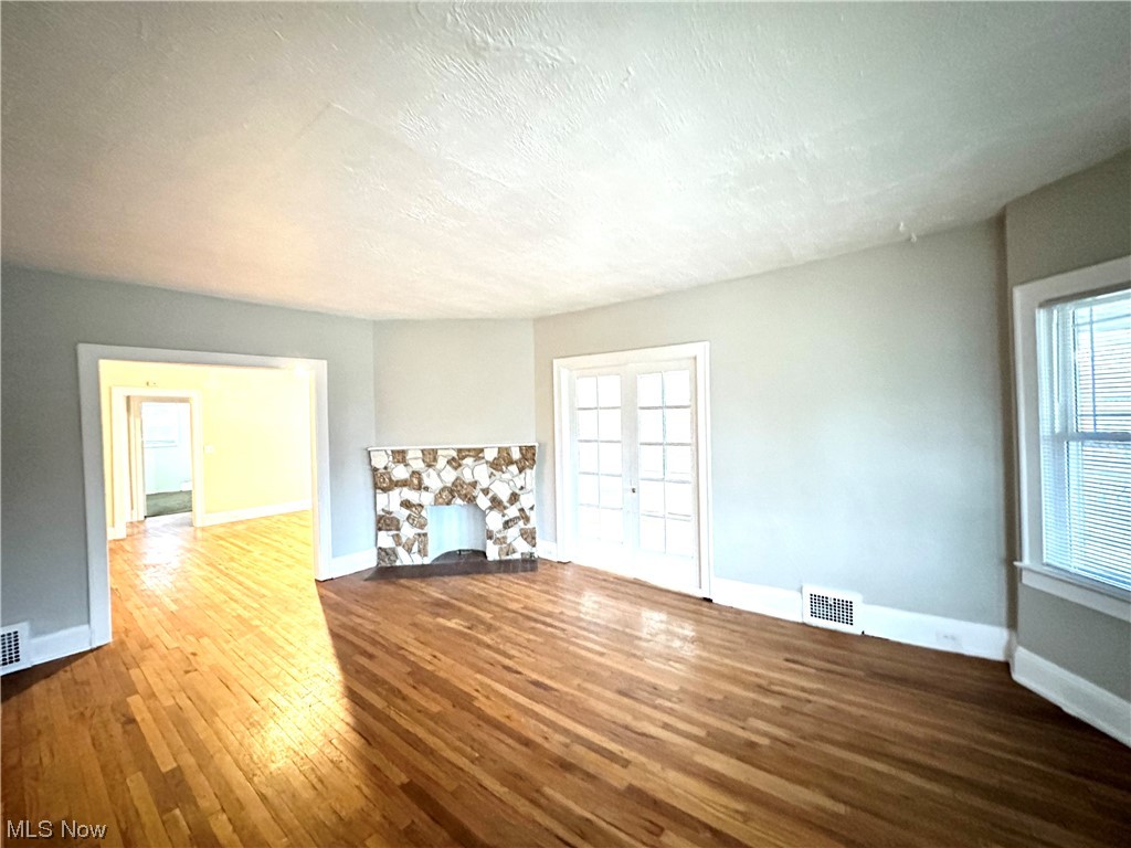 3228 Berkeley Road Cleveland, OH 44118 - Photo 9 of 26 Living room with a stone fireplace and dark hardwood / wood-style floors