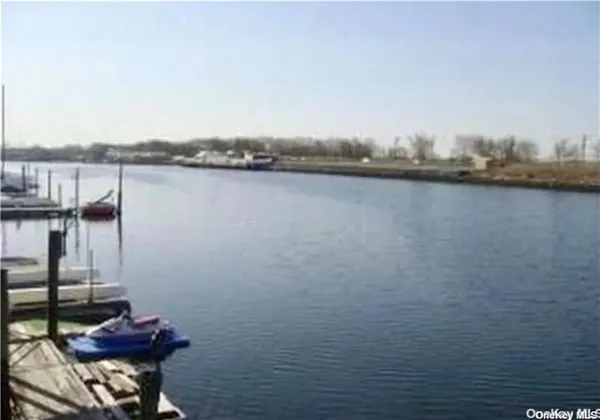 a view of a lake with chairs