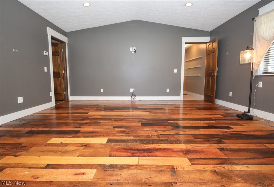 38610 Spiedel Town Road Bethesda, OH 43719 - Photo 20 of 33 Unfurnished bedroom featuring vaulted ceiling and hardwood / wood-style floors