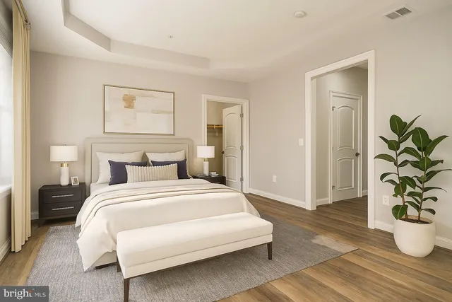 a bedroom with a bed and a potted plant